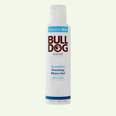 A white can of Sensitive Foaming Shave Gel with blue and brown text, featuring the Bulldog logo and details about willow herb, baobab oil, and natural origin ingredients for sensitive skin.