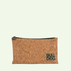 The Bulldog Cork Washbag is a rectangular pouch made of cork, featuring a zipper with a round pull tab. BULLDOG and SKINCARE are printed in green on the lower right corner against a plain, light background.