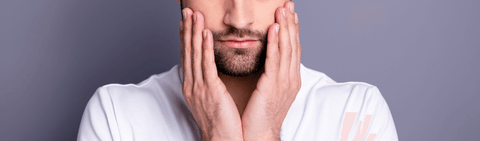 Man touching face
