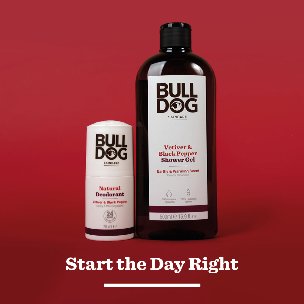 Two Bulldog Skincare products—Vetiver & Black Pepper Natural Deodorant with 24-hour odour protection and Vetiver & Black Pepper Shower Gel—stand side by side against a solid red background. Text below reads: “Start the Day Right.”.
