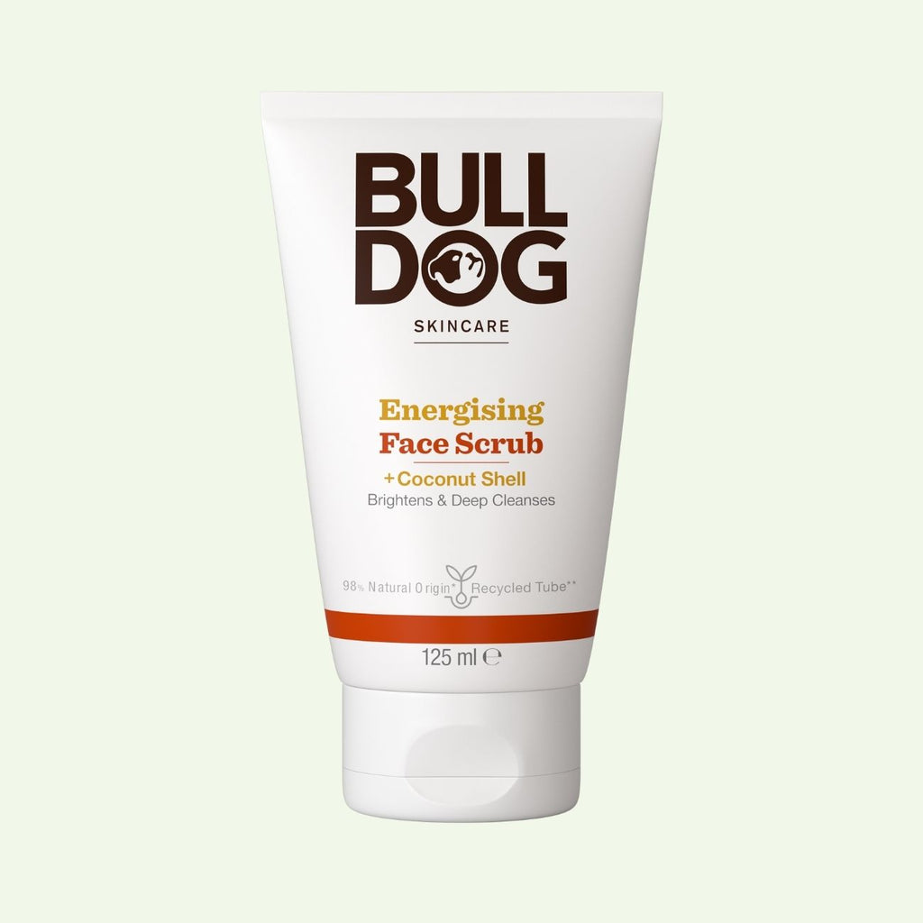 A 125ml white tube of Energising Face Scrub for men, featuring natural exfoliants like coconut shell to brighten and deeply cleanse skin, stands upright on a light background.