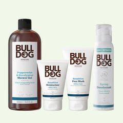 The Sensitive Spray Deodorant Bundle includes a large shower gel, moisturizer, face wash, and spray deodorant—each in white packaging with brown and green text—for an elevated grooming experience.