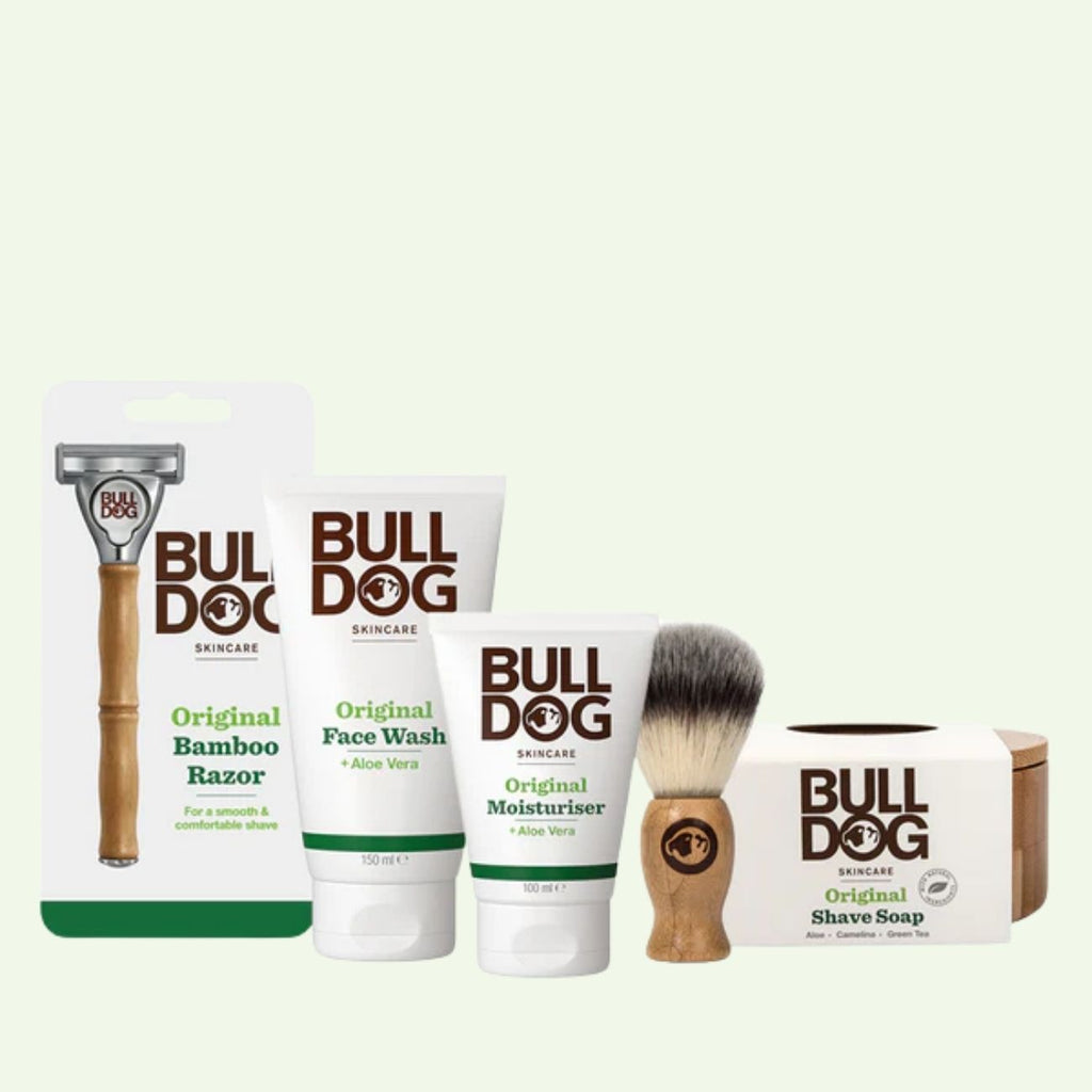 The Premium Shave Collection Bundle, including a Bamboo Razor, face wash, moisturizer, shaving brush, and original shave soap, is arranged on a light background.