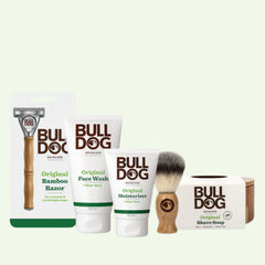 The Premium Shave Collection Bundle, including a Bamboo Razor, face wash, moisturizer, shaving brush, and original shave soap, is arranged on a light background.