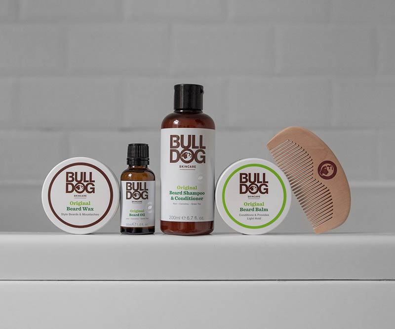 Bulldog Skincares Original Beard Oil with natural ingredients is displayed on a white surface against a tiled background.